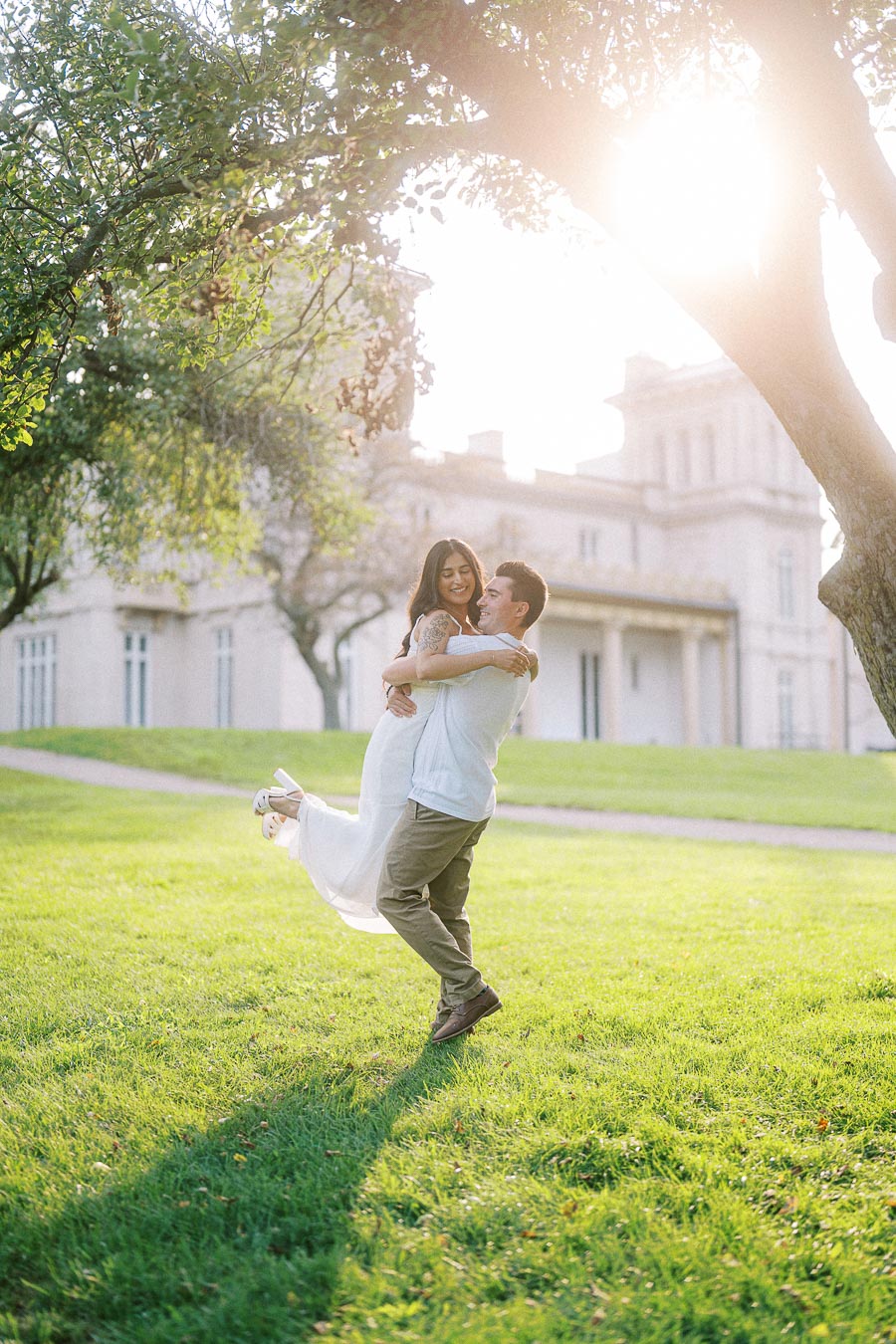Sumbul and Brian laughing on Dundurn Castle lawn during engagement session