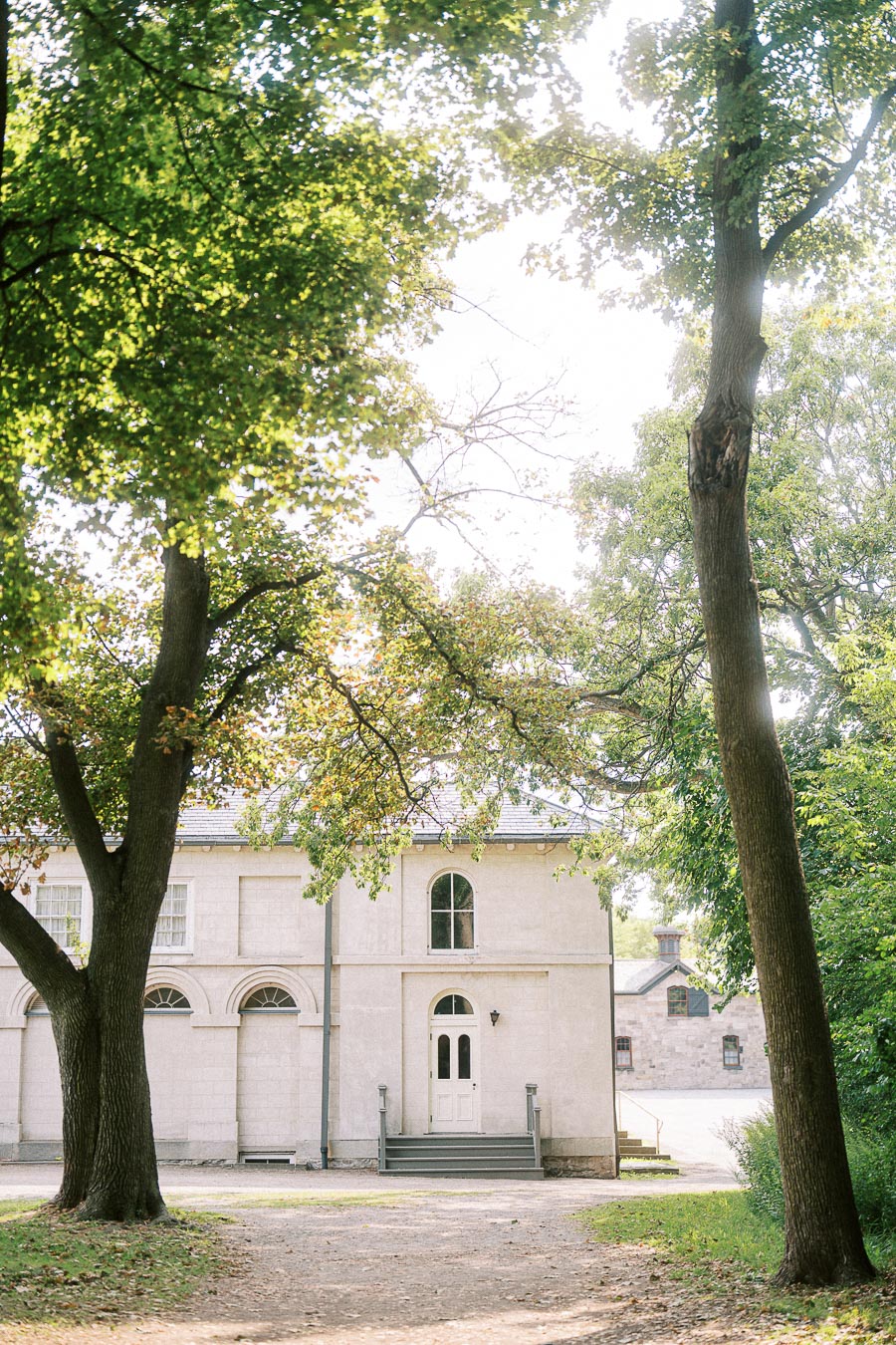 Tree-framed historic building on the Dundurn Castle grounds in Hamilton