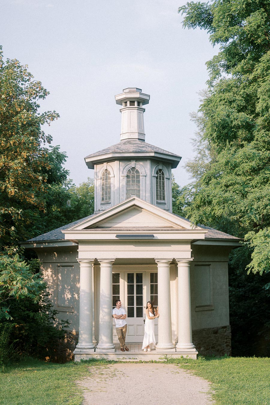 Sumbul and Brian standing beneath columns at Dundurn Castle in Hamilton