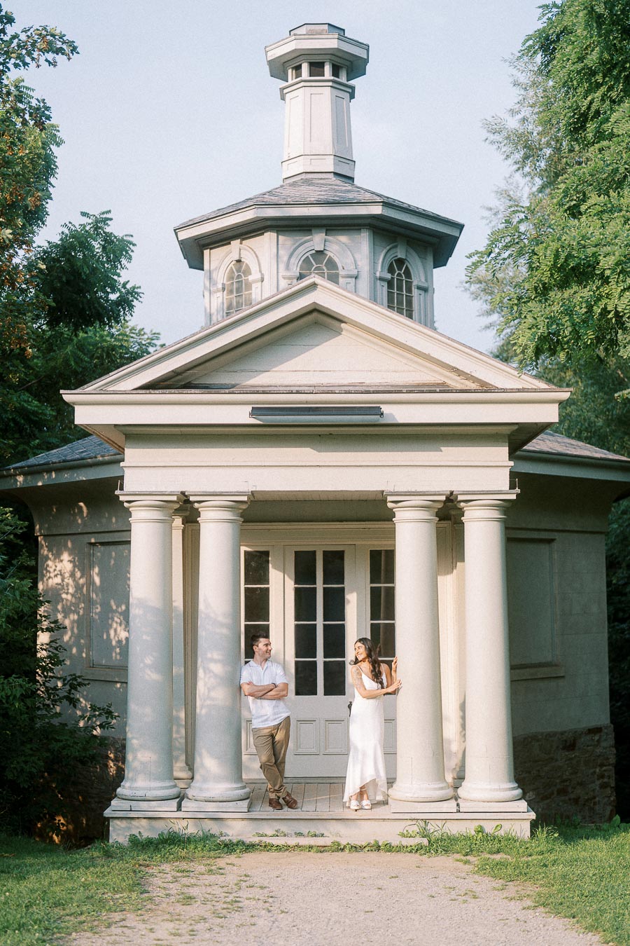 Sumbul and Brian standing beneath Dundurn Castle colonnade in Hamilton
