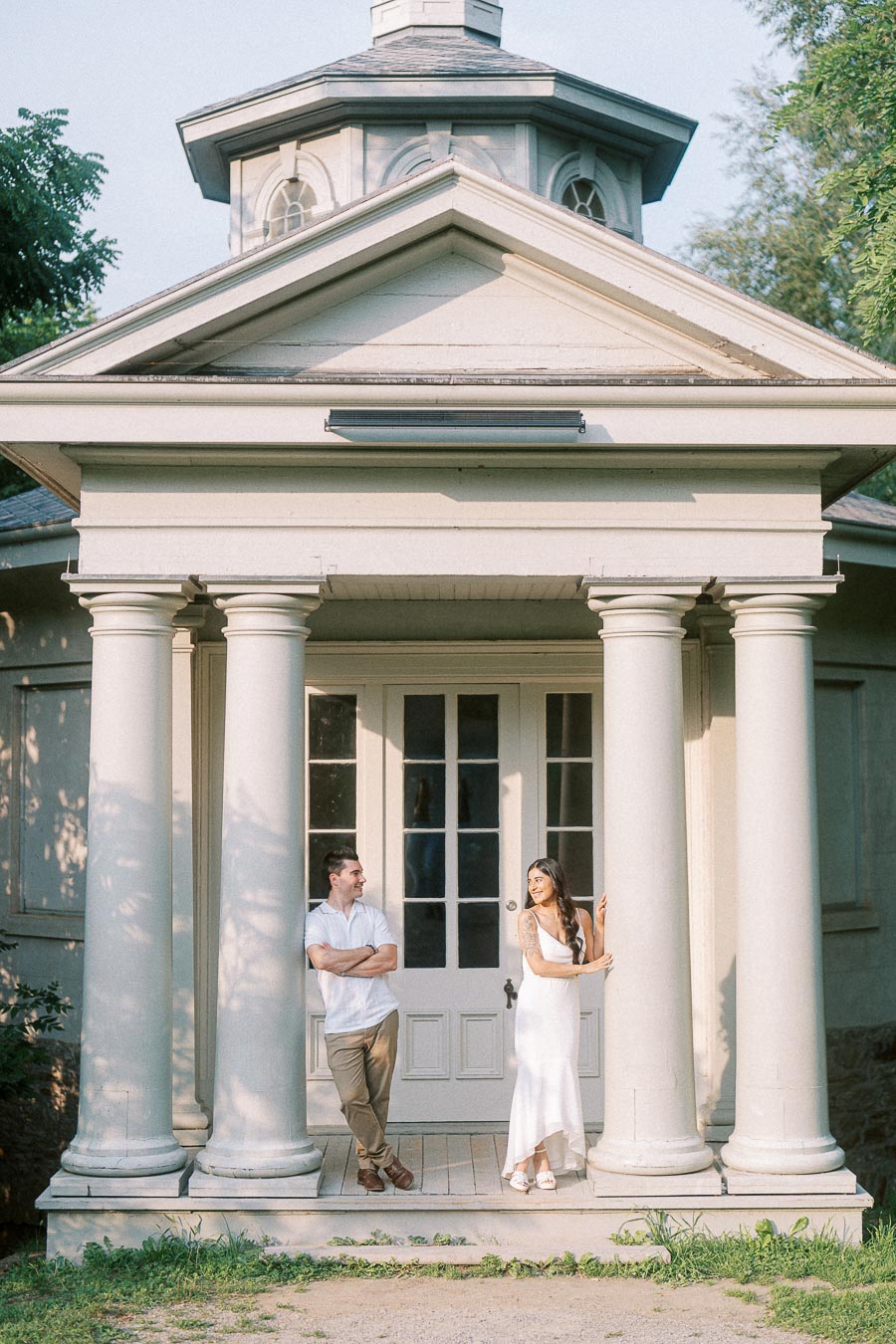 Sumbul and Brian standing under white columns at Dundurn Castle in Hamilton