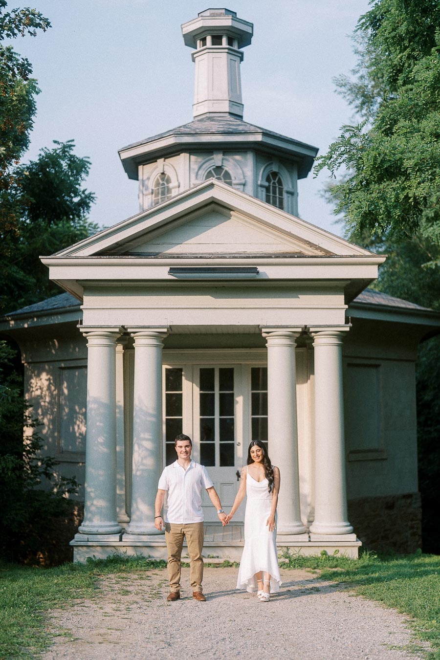 Sumbul and Brian holding hands outside a columned pavilion at Dundurn Castle