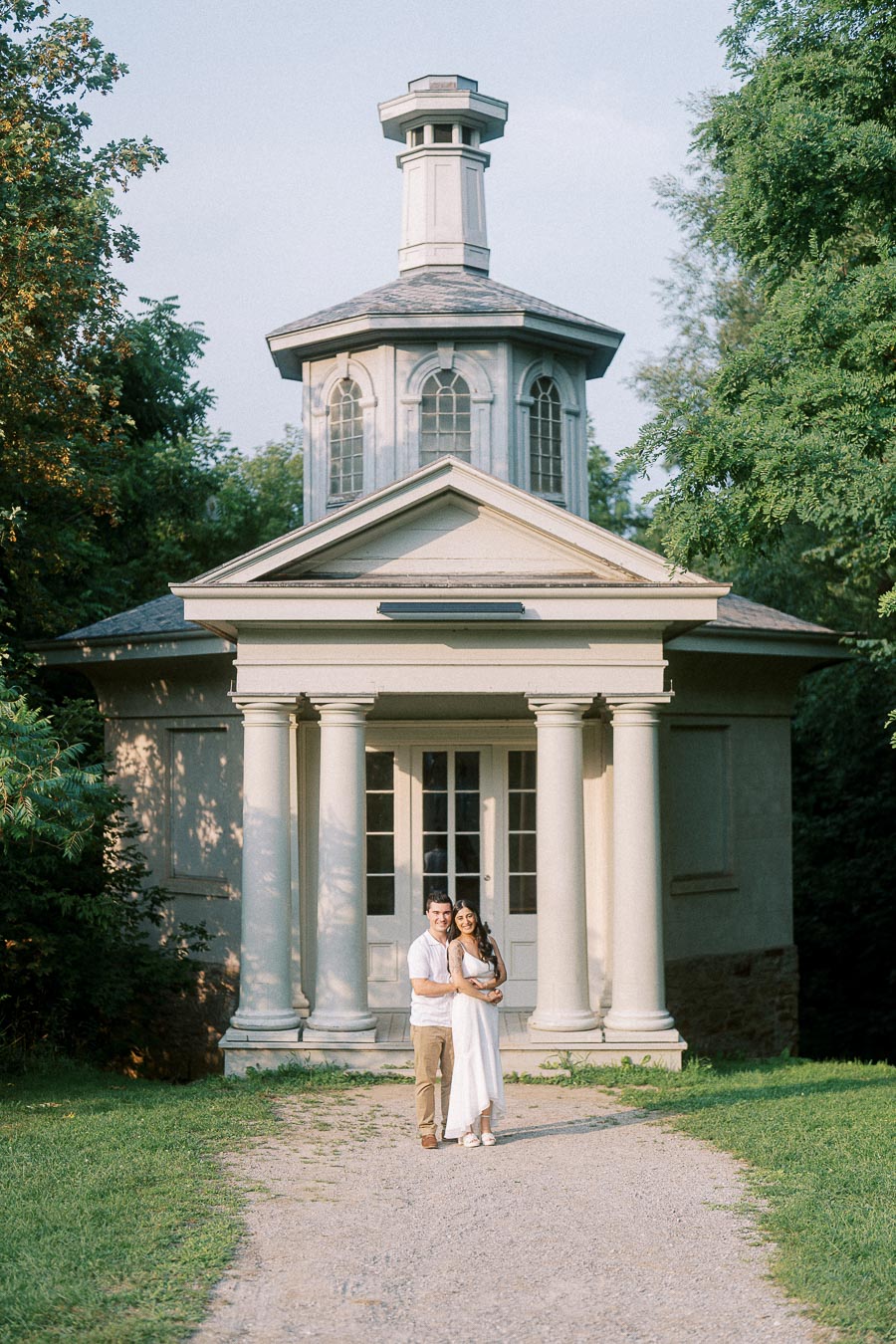 Sumbul and Brian standing before a Dundurn Castle garden pavilion in Hamilton