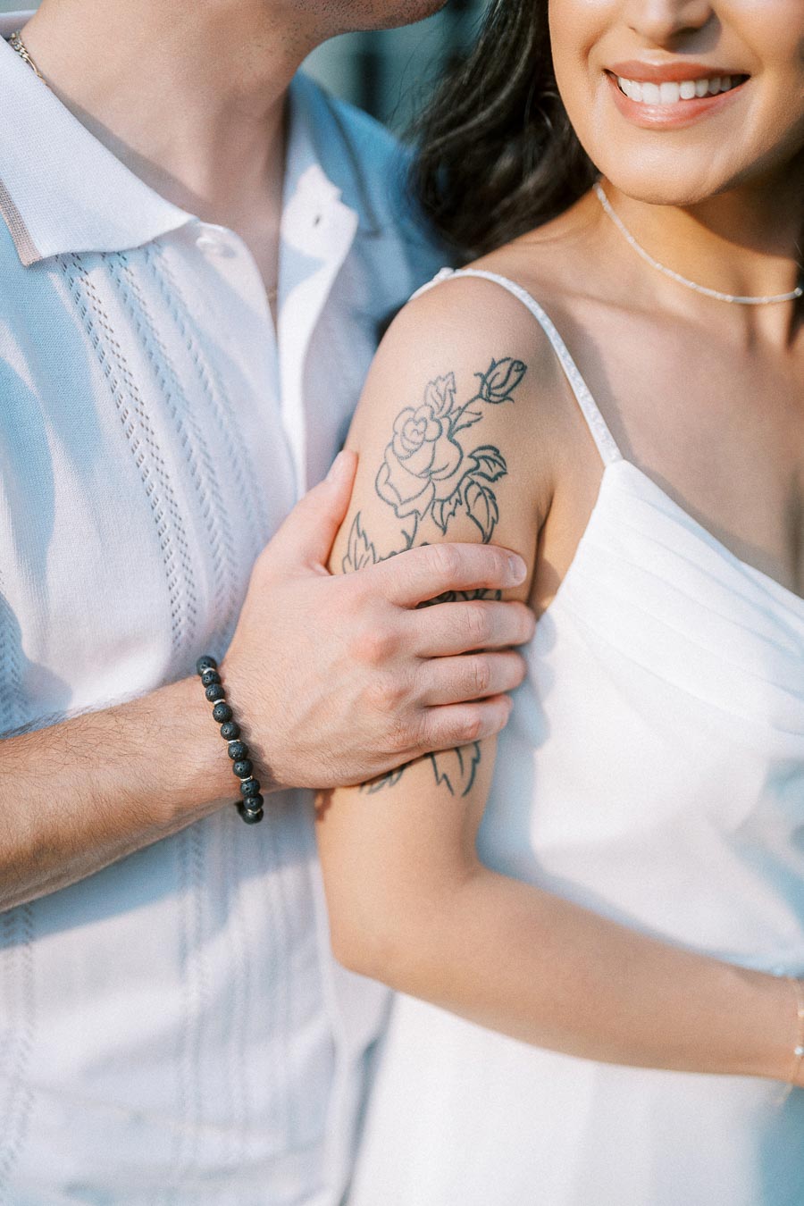 Close-up engagement portrait showing floral arm tattoo at Dundurn Castle