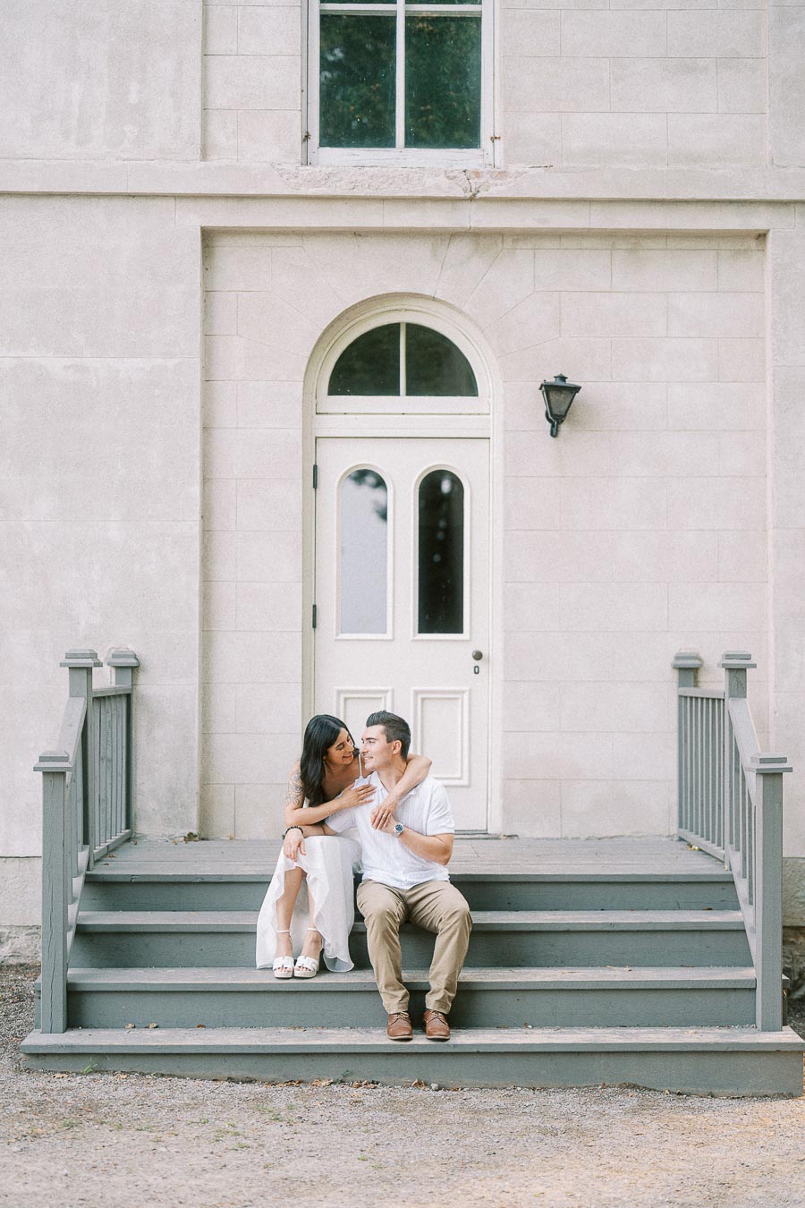 Couple seated on Dundurn Castle steps during Hamilton engagement session