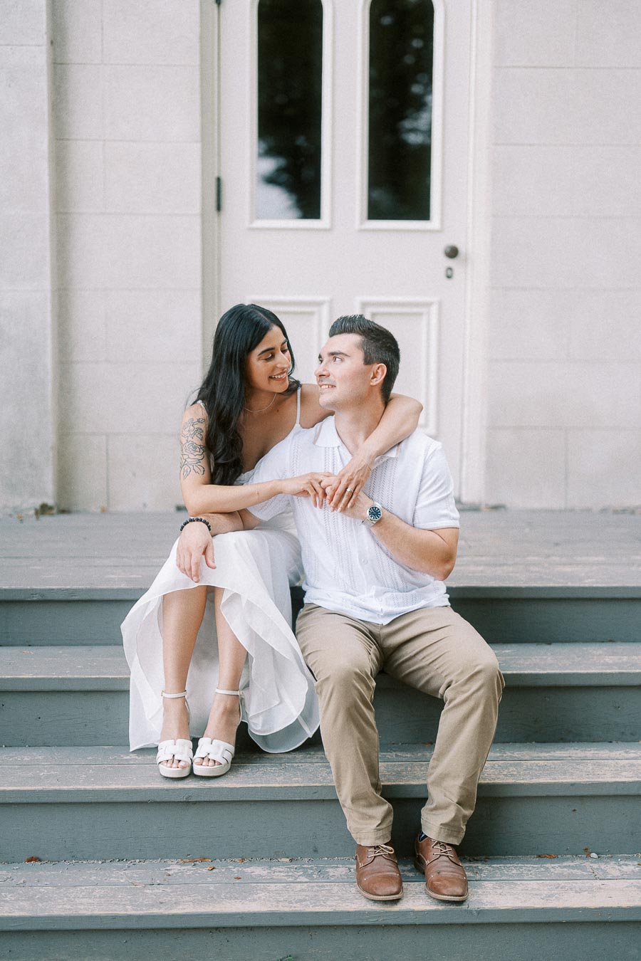 Sumbul and Brian sitting on Dundurn Castle steps during engagement portraits