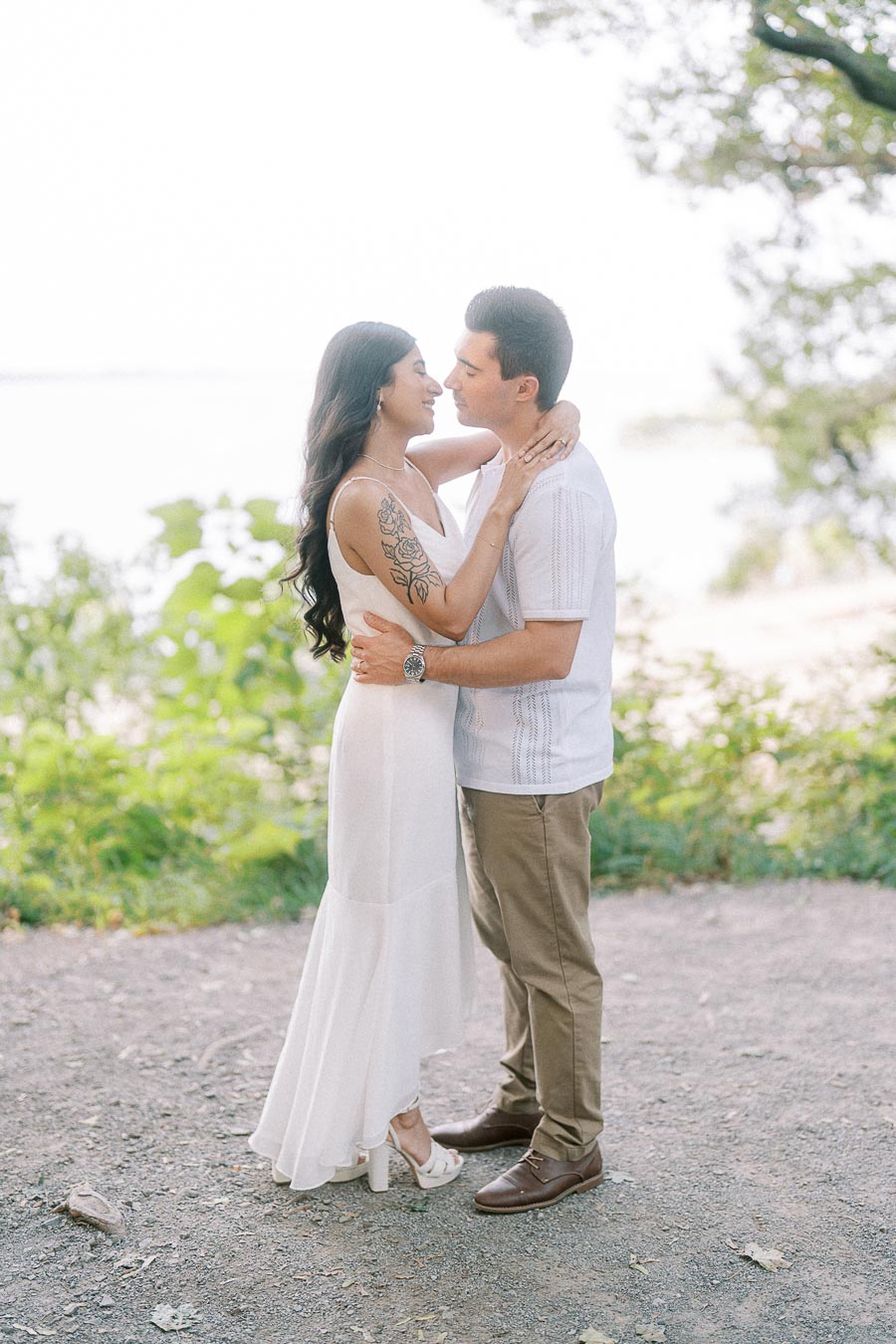 Engaged couple embracing outdoors during Dundurn Castle engagement photoshoot