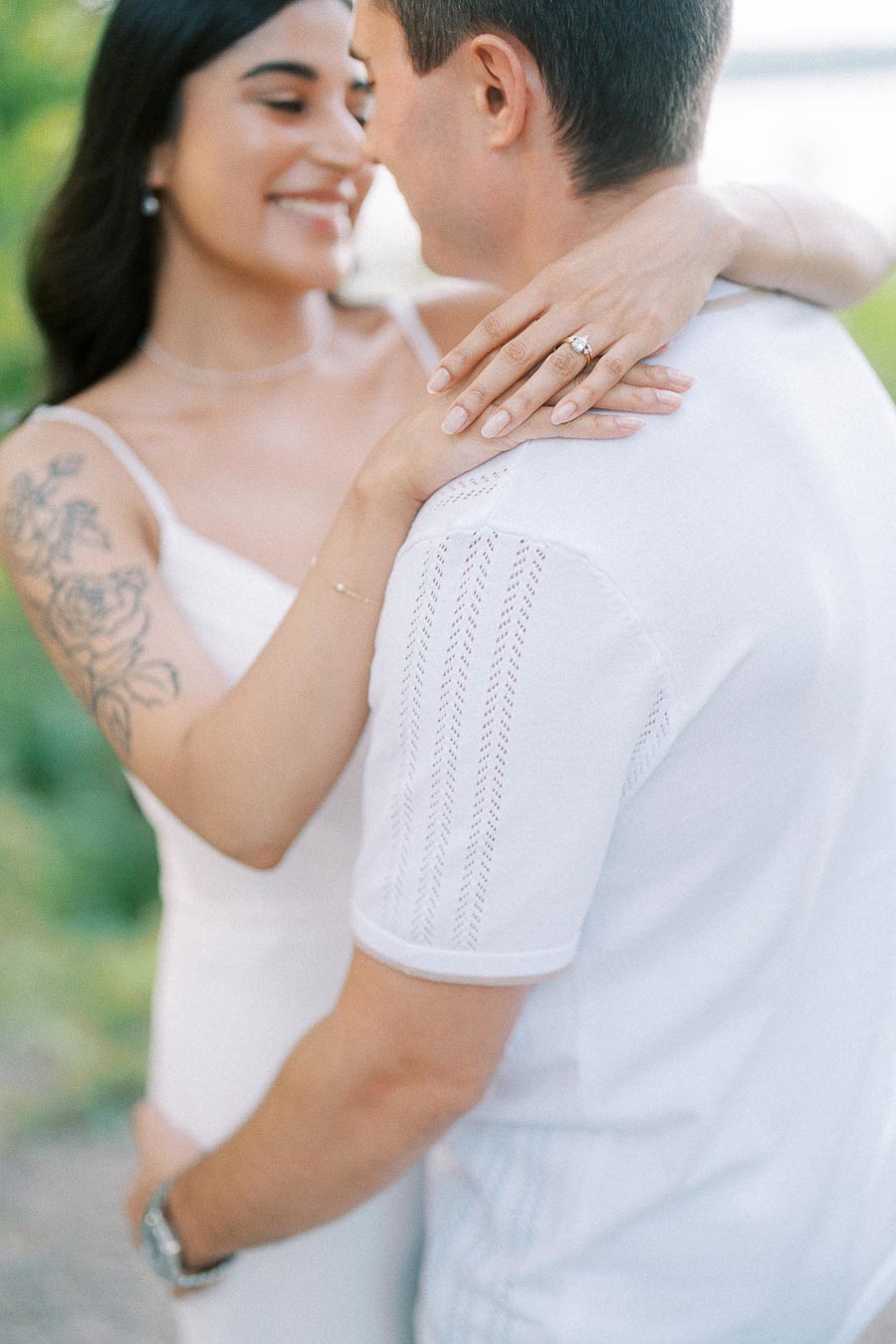 Engaged couple embracing with diamond ring during Dundurn Castle engagement session
