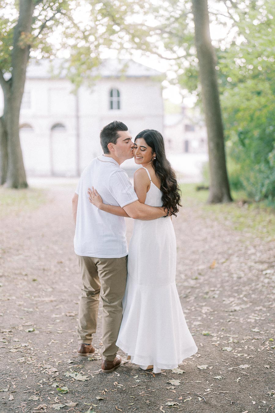 Sumbul and Brian embracing on a tree-lined path at Dundurn Castle