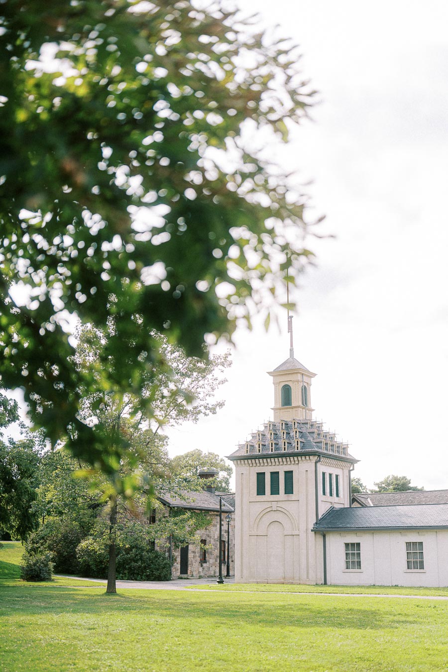 Dundurn Castle grounds with tower framed by leafy trees in Hamilton
