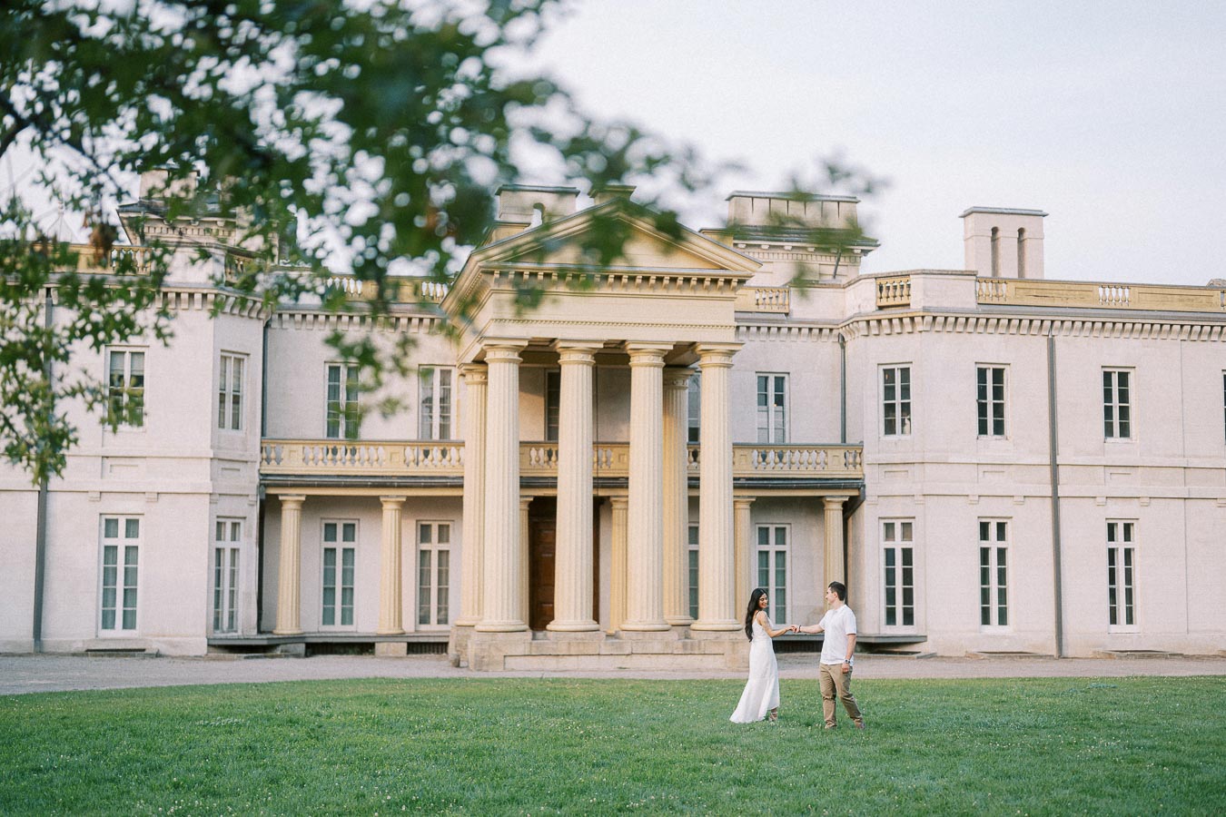 Sumbul and Brian holding hands on the lawn at Dundurn Castle