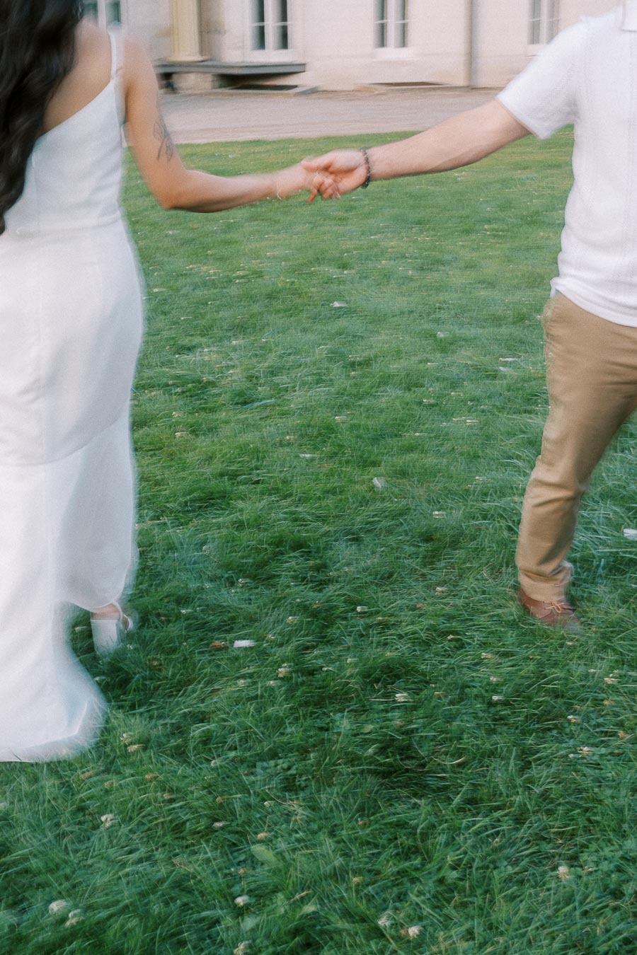 Sumbul and Brian holding hands on the Dundurn Castle lawn