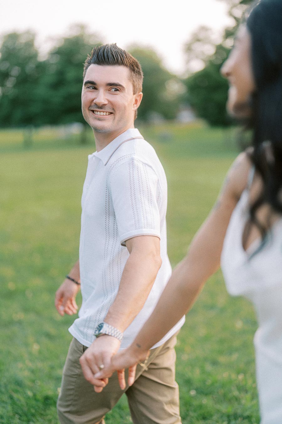 Brian smiling while holding Sumbul’s hand during Dundurn Castle engagement session
