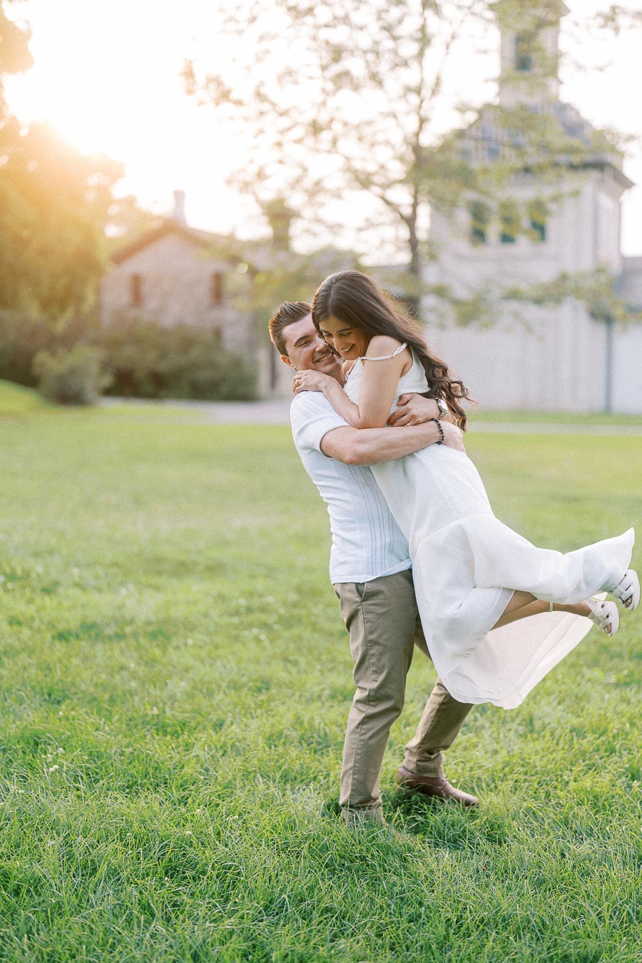 Couple embracing on the lawn during Dundurn Castle engagement photography