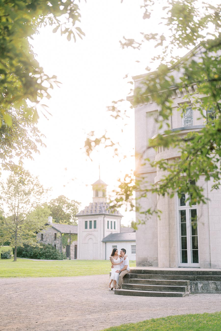 Couple seated on Dundurn Castle steps during Hamilton engagement session