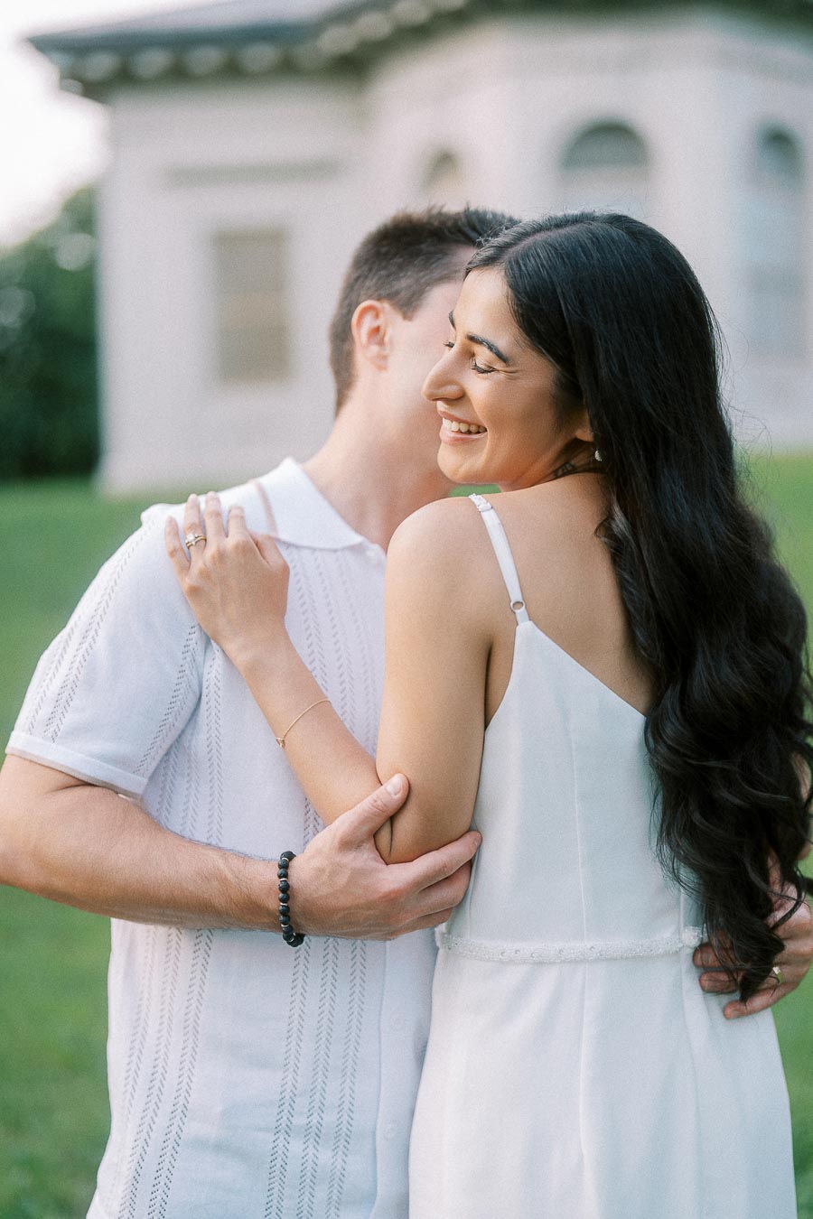 Sumbul smiling in Brian’s embrace during a Dundurn Castle engagement session