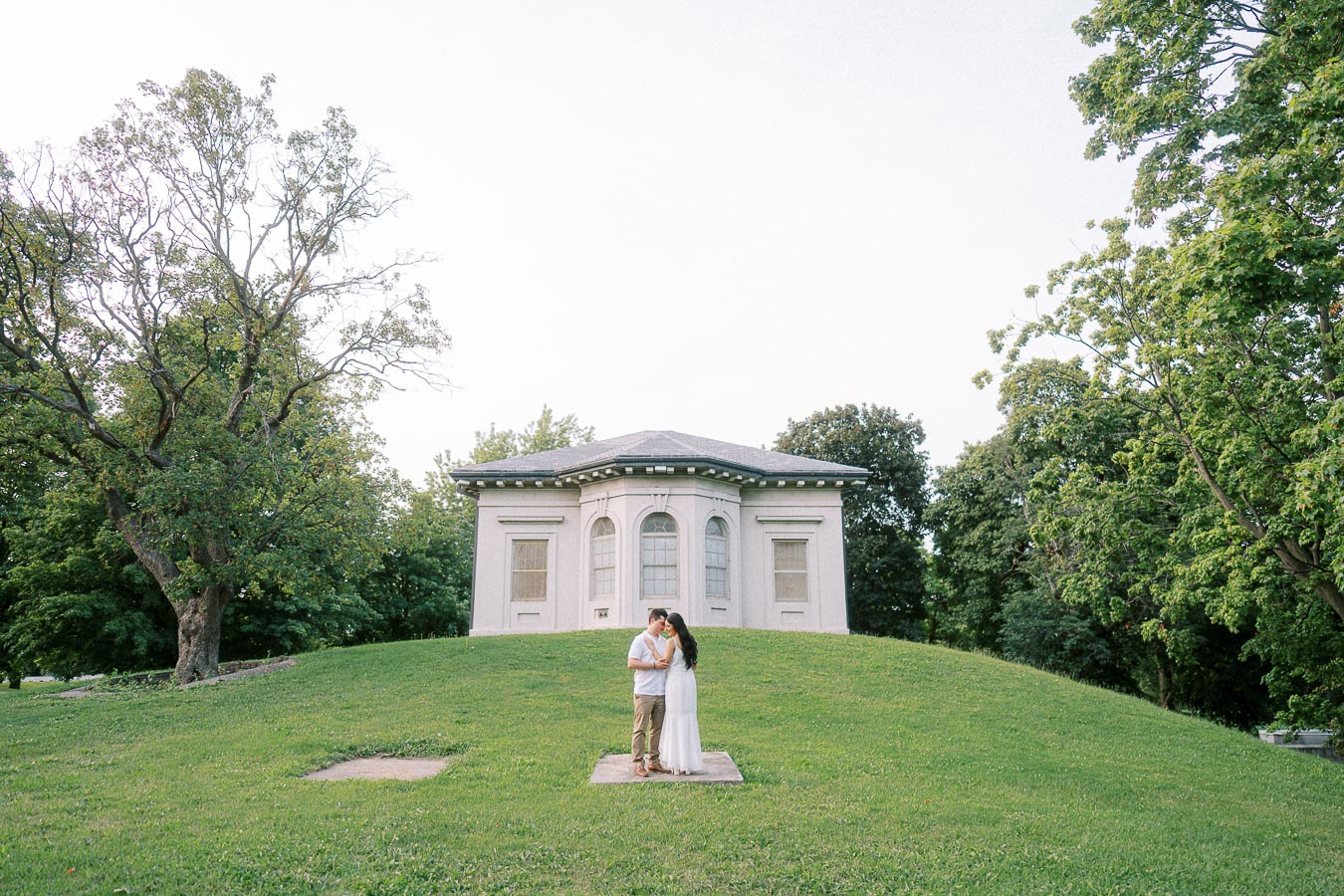 Couple embracing on lawn near Dundurn Castle grounds in Hamilton