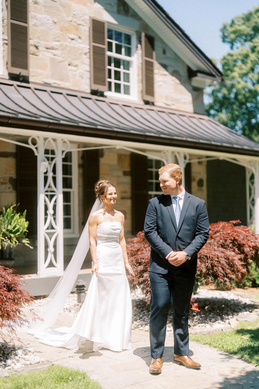 Bride and groom share a first look outside a stone private estate near Chatham Kent, Ontario, during an outdoor wedding.
