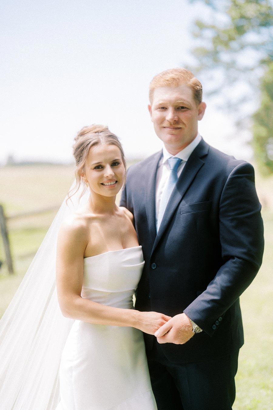 Bride and groom posing outdoors on a rural private estate near Chatham-Kent, Ontario, Canada.