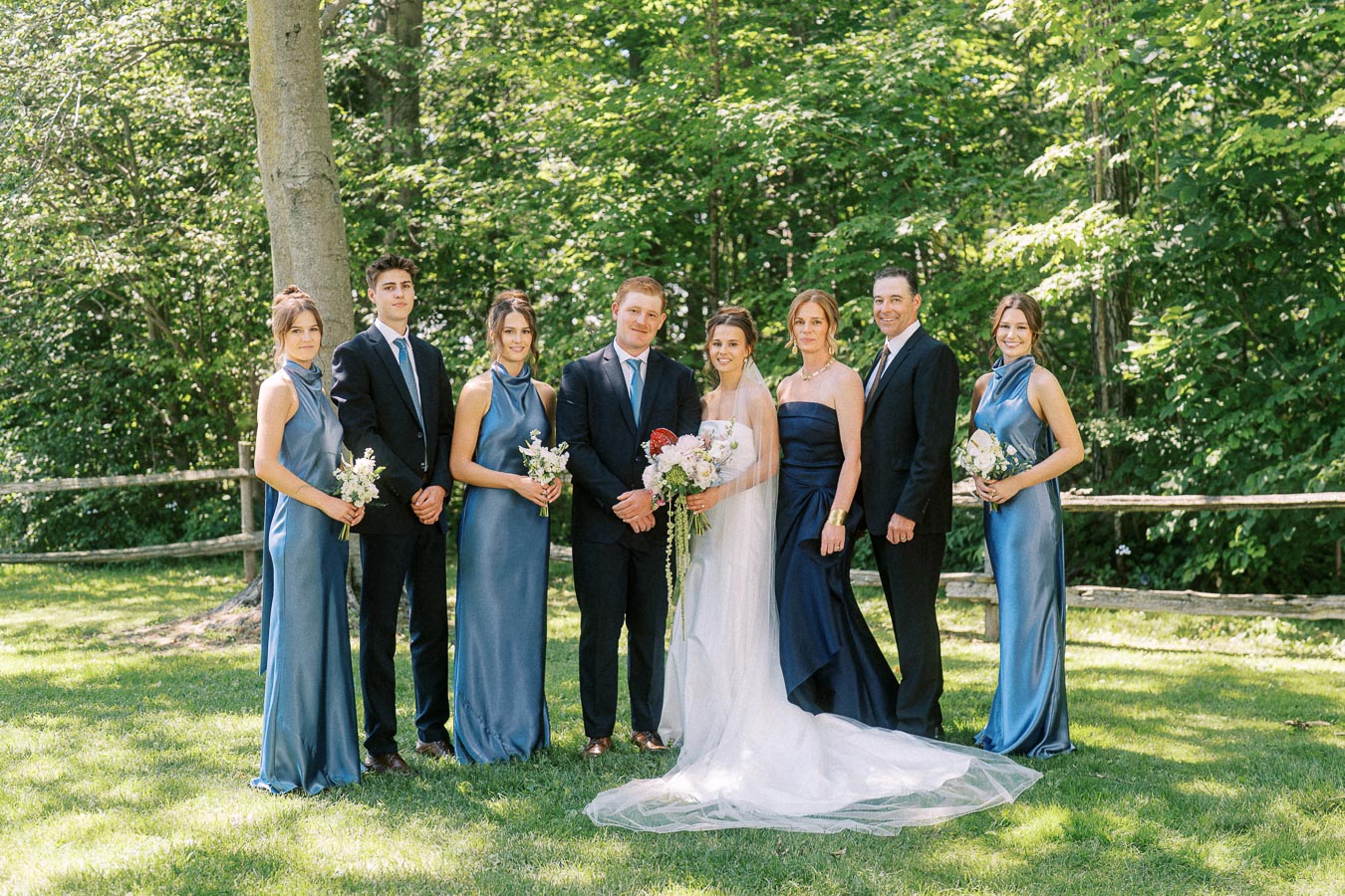 Bride, groom, relatives, and wedding party pose outdoors on a private estate lawn near Chatham-Kent, Ontario, Canada.