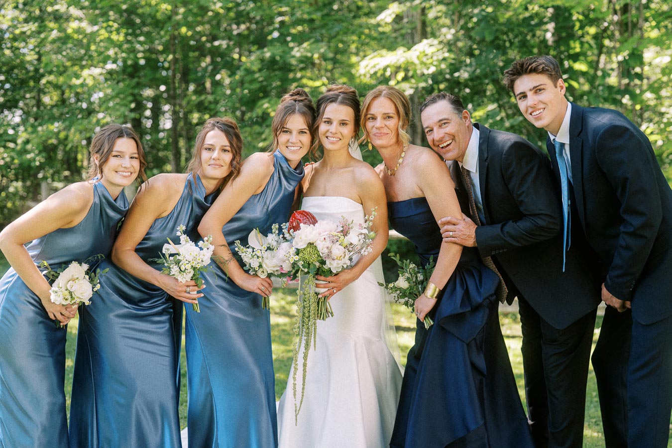 Bride with bridesmaids and relatives posing outdoors in a wooded private estate near Chatham-Kent, Ontario, Canada.