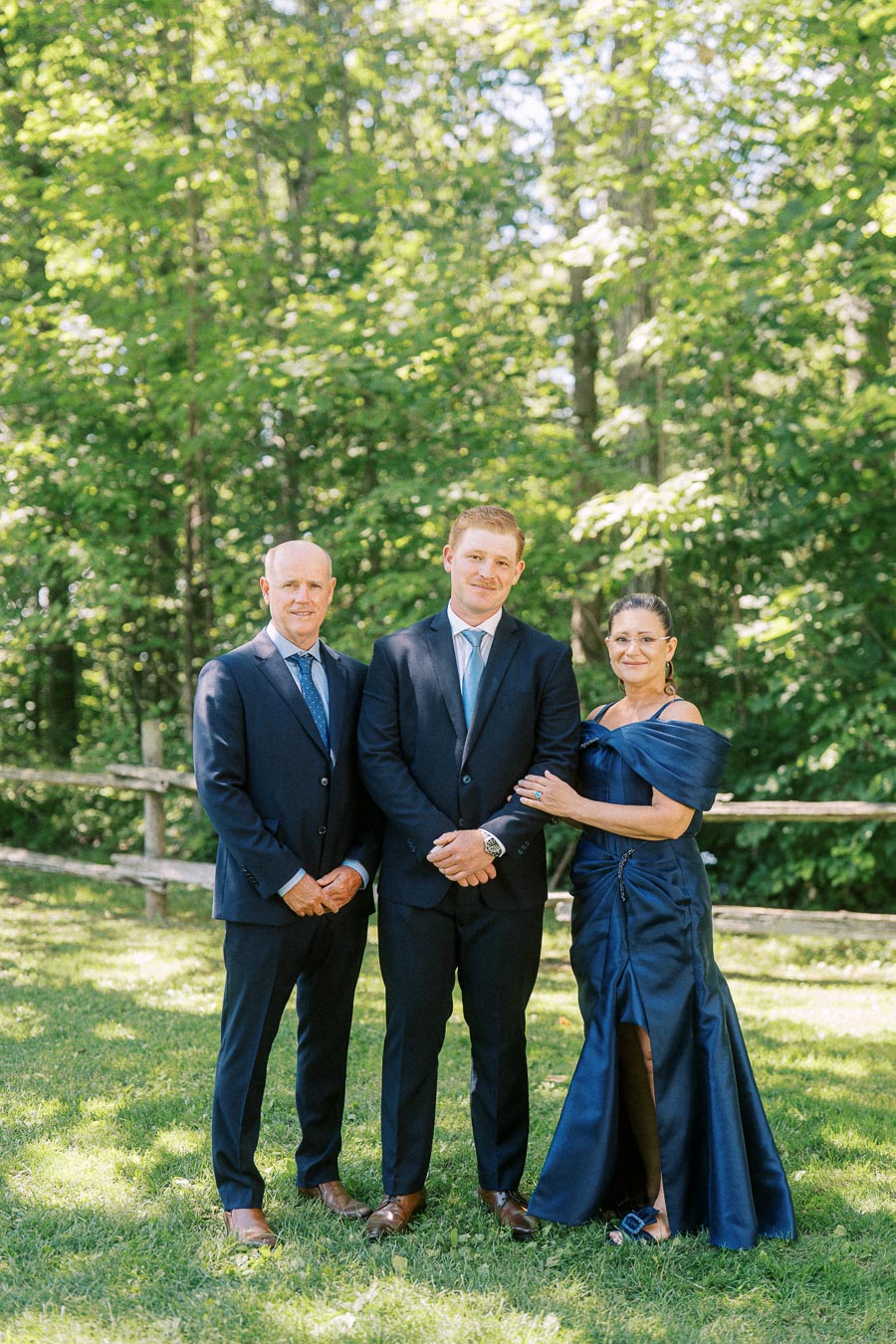 Wedding family portrait with groom and relatives on a wooded private estate near Chatham-Kent, Ontario, Canada.