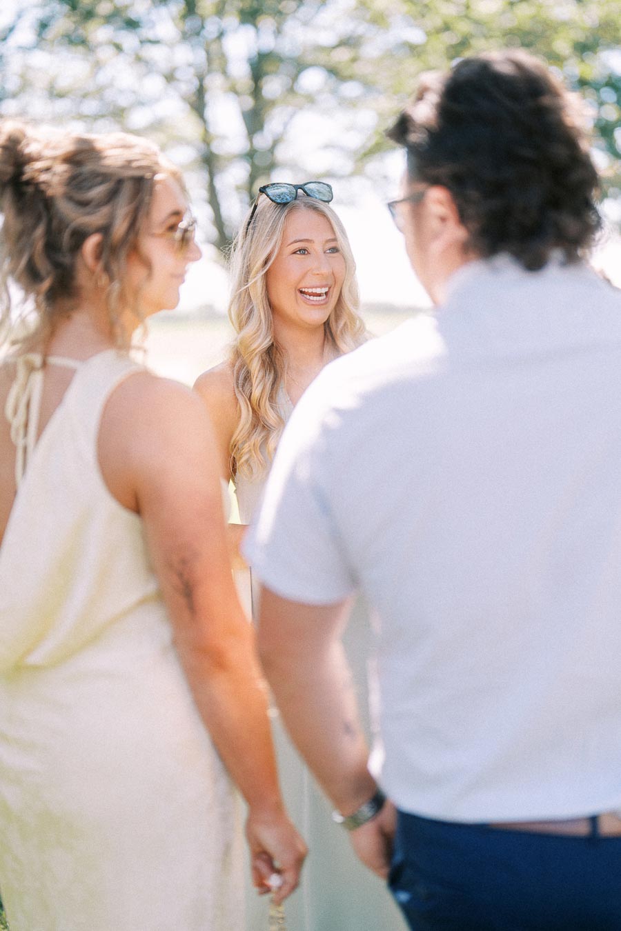 Wedding guests chatting outdoors during cocktail hour at a private estate wedding near Chatham-Kent, Ontario, Canada.