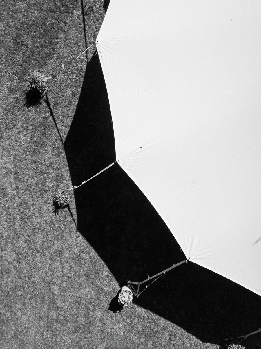 Black and white overhead view of a large white wedding tent on a grassy private estate near Chatham-Kent, Ontario.