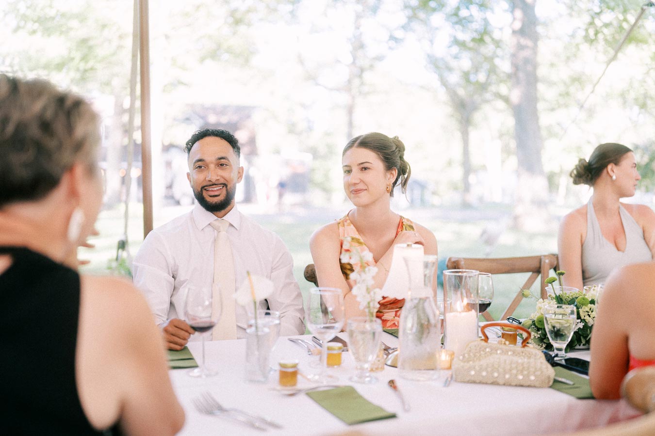 Wedding guests dining under a tent at an outdoor private estate reception near Chatham-Kent, Ontario.