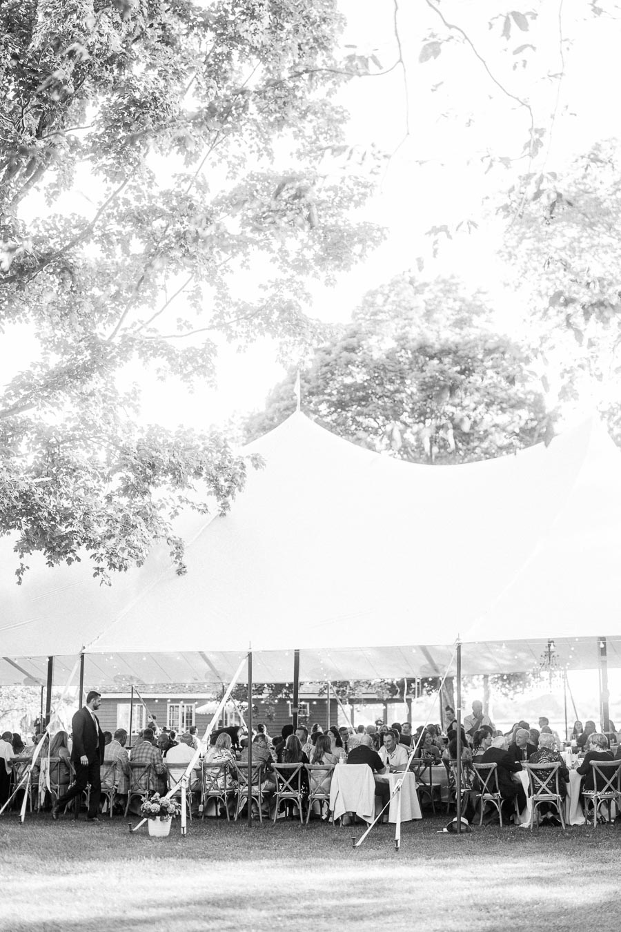 Black and white outdoor wedding reception under a large white tent on a private farm estate near Chatham-Kent, Ontario, Canada.