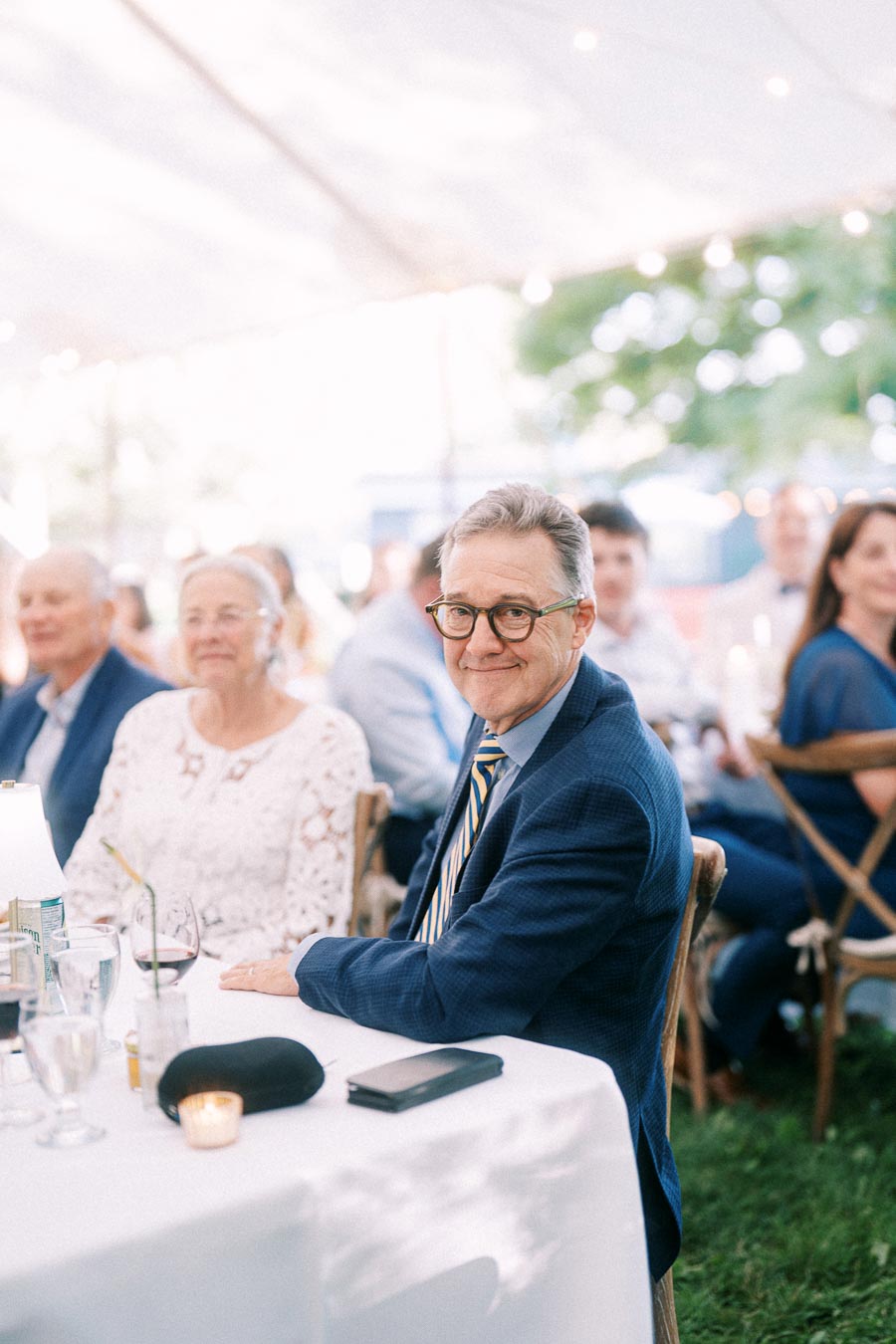 Wedding guests seated at a tented outdoor reception on a private farm estate near Chatham-Kent, Ontario, Canada.