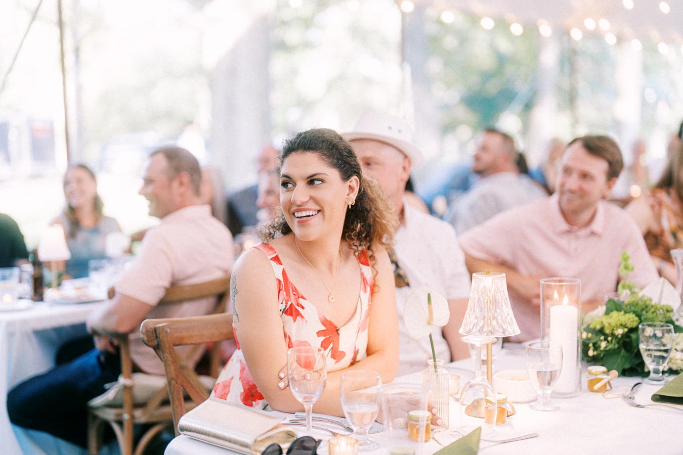 Wedding guests seated at a decorated dinner table inside a tented outdoor reception near Chatham-Kent, Ontario, Canada.