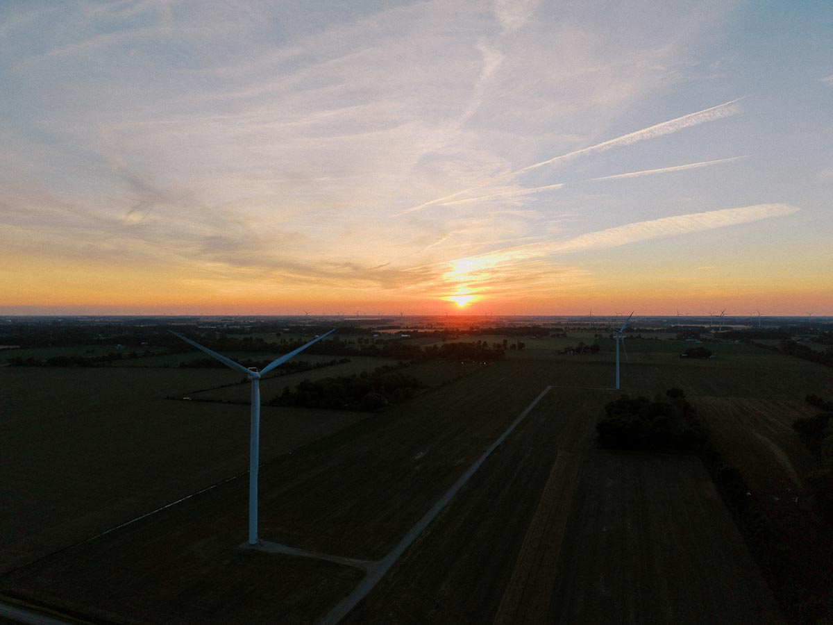 Sunset over farmland with wind turbines near Chatham-Kent, Ontario, Canada.