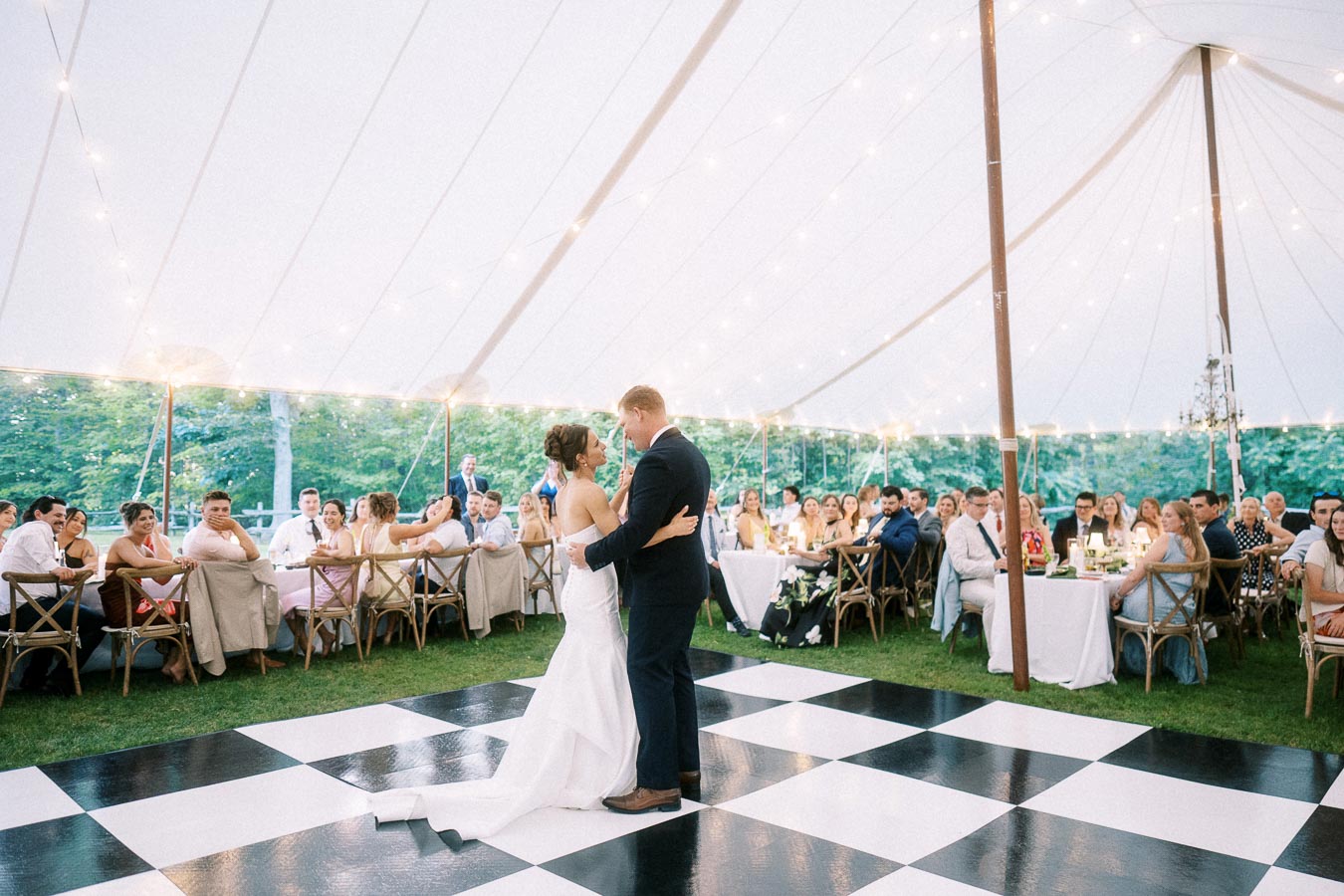 Bride and groom dancing under a white wedding tent with guests seated at round tables on a private farm estate near Chatham-Kent, Ontario.