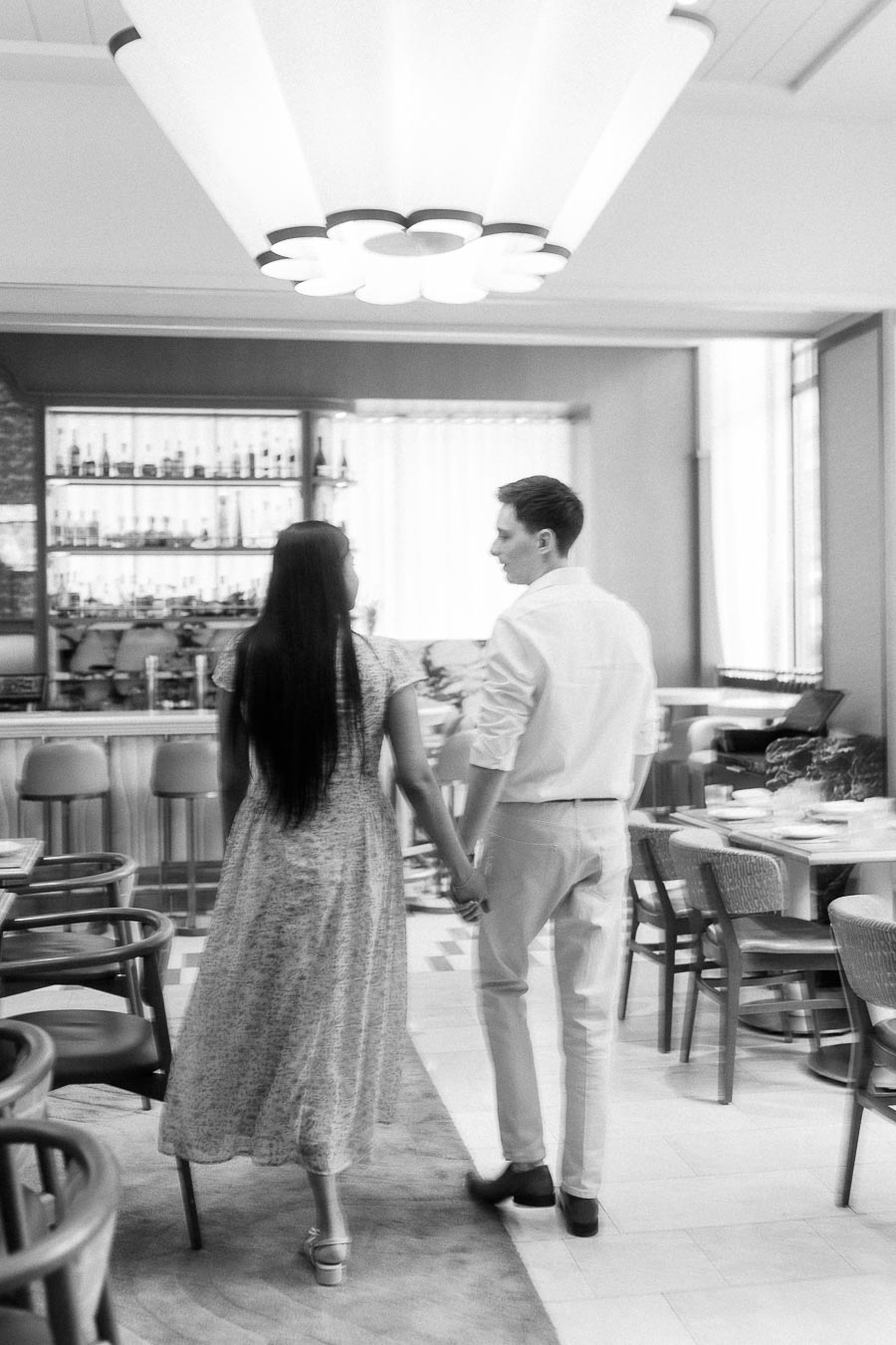 Couple holding hands in a stylish Toronto restaurant dining room