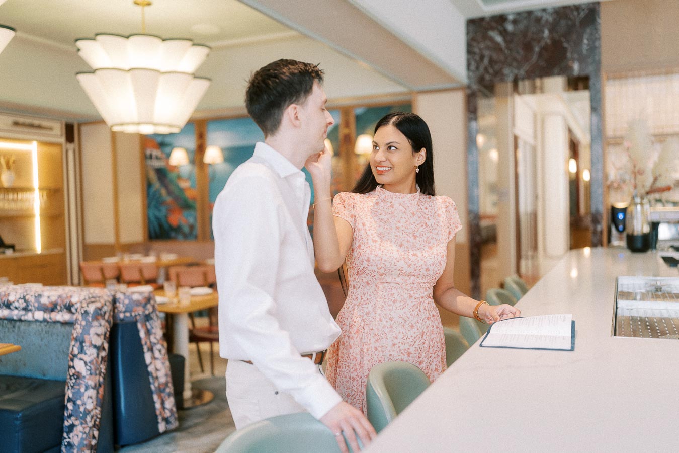 Couple standing at a stylish hotel bar during their Toronto engagement session