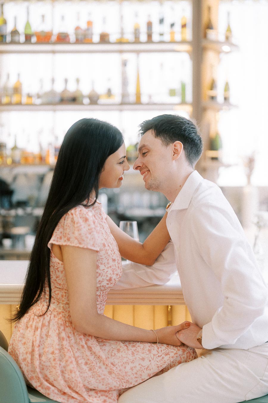 Mike and Becky smiling nose to nose at a bright Toronto bar