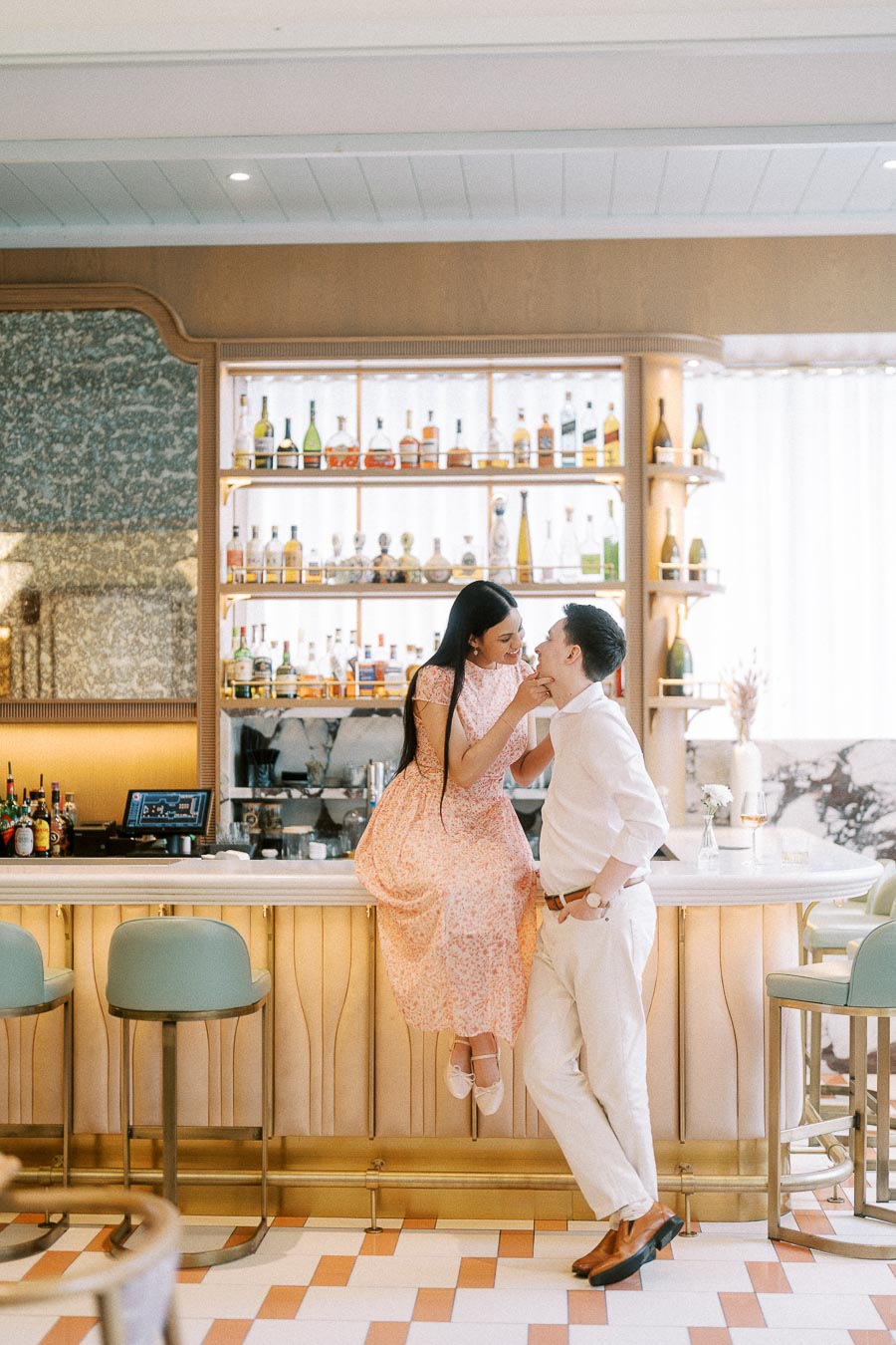 Couple sharing a playful moment at a bright Toronto bar