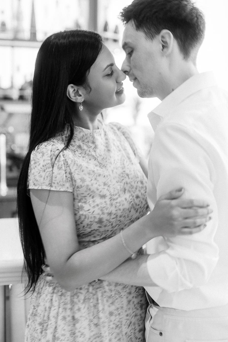 Black and white close-up of Mike and Becky embracing indoors