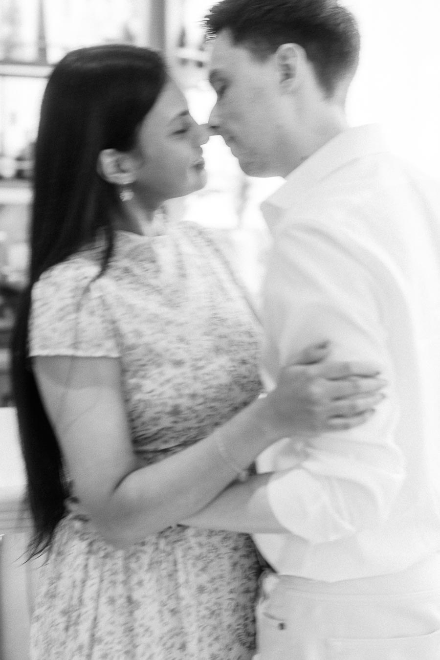 Black and white close-up of Mike and Becky leaning in for a kiss