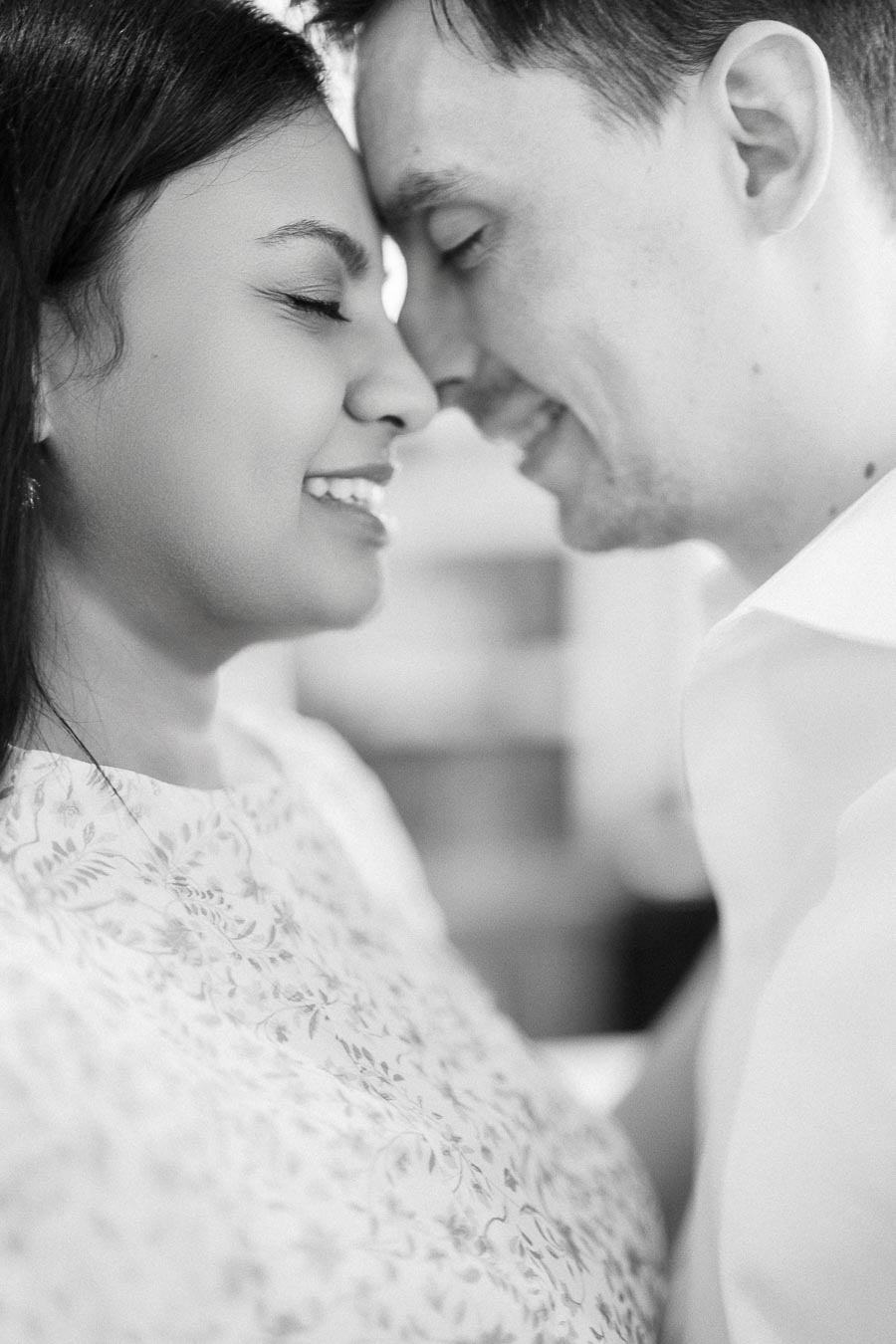 Black and white close-up of Mike and Becky smiling forehead to forehead