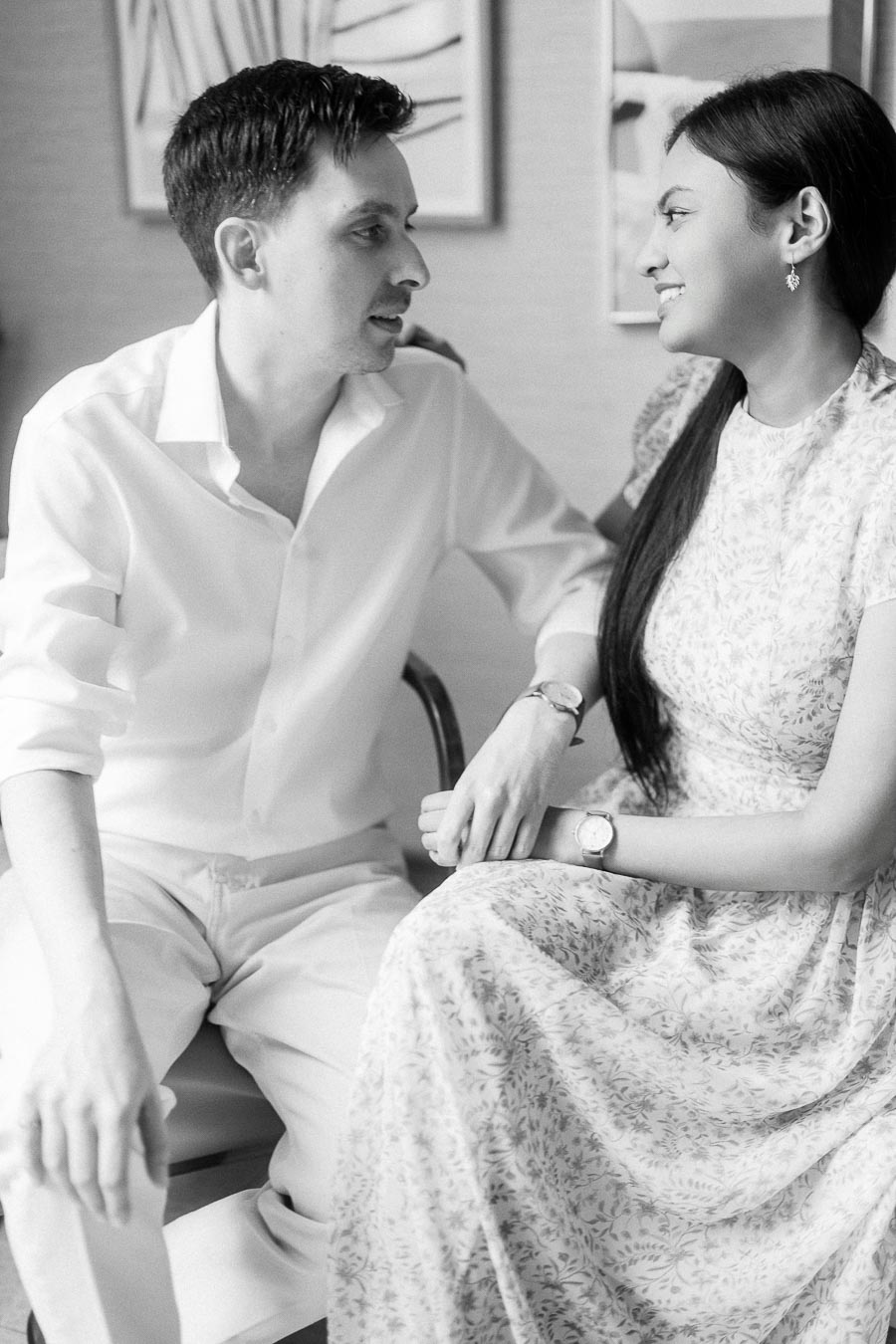 Black and white portrait of Mike and Becky sitting close and smiling indoors