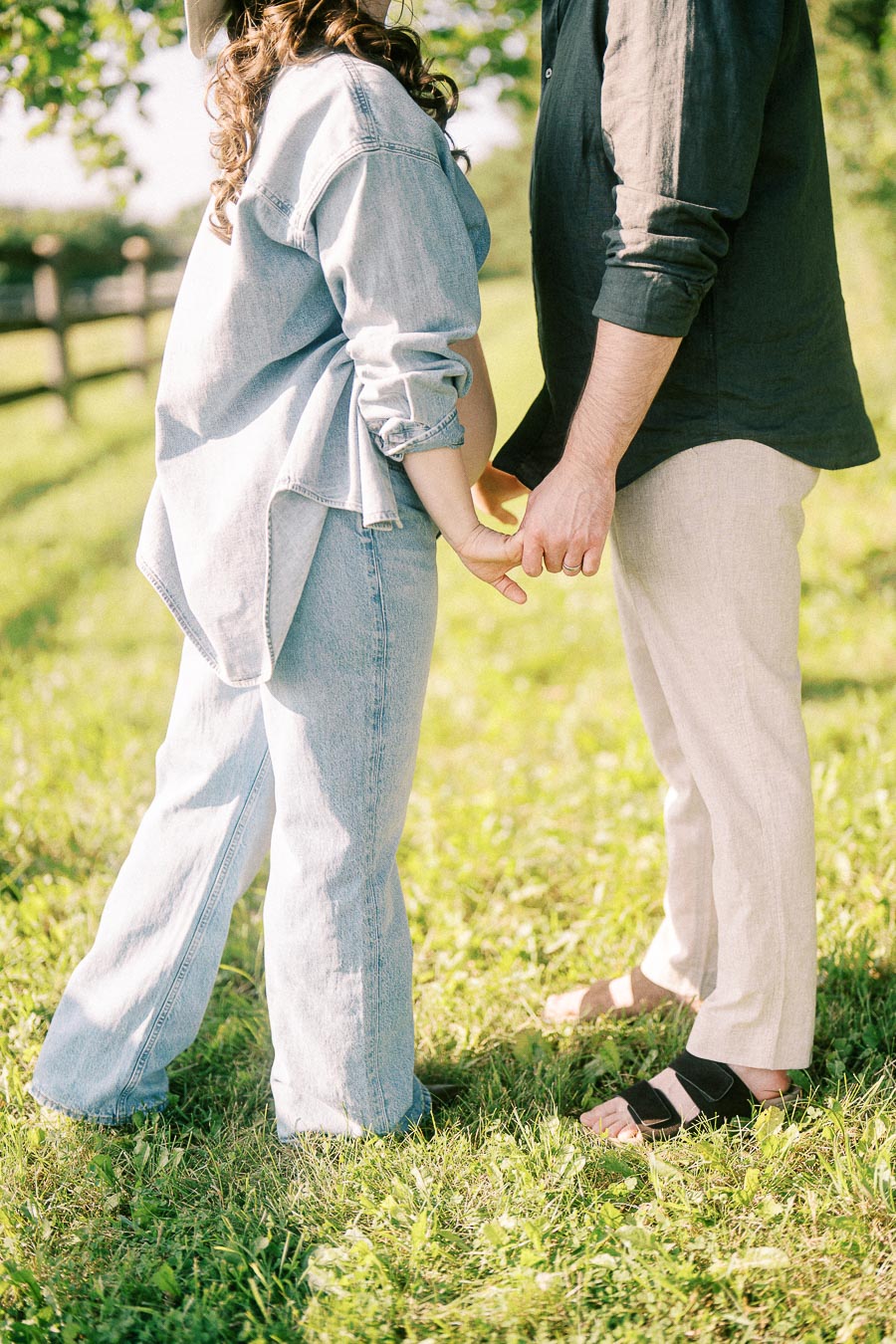Couple holding hands in grassy field at The Green Acres in Flamborough