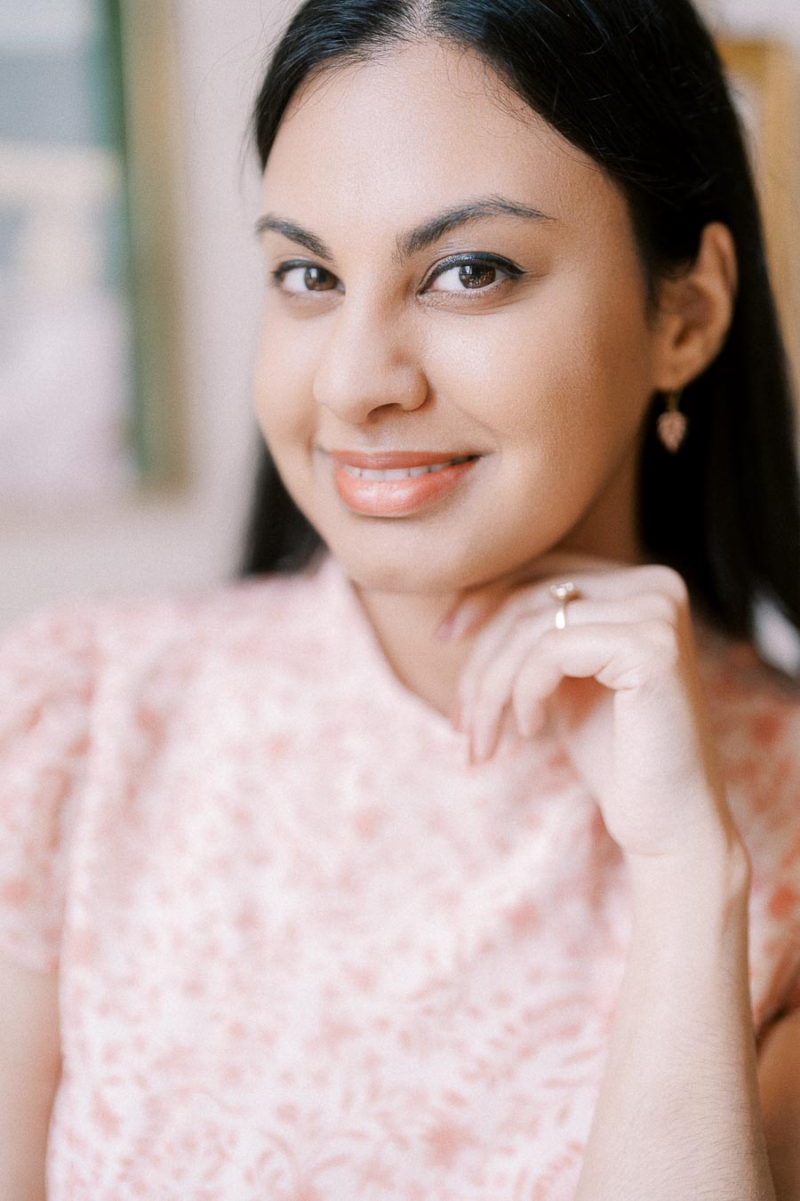 Close-up portrait of Becky smiling softly with engagement ring visible