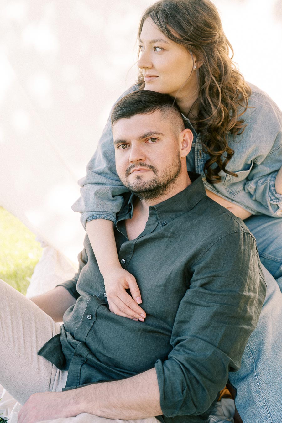 Expectant couple embracing during a maternity session at The Green Acres
