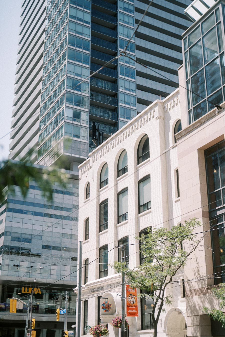 Downtown Toronto buildings with arched brick façade and glass high-rises