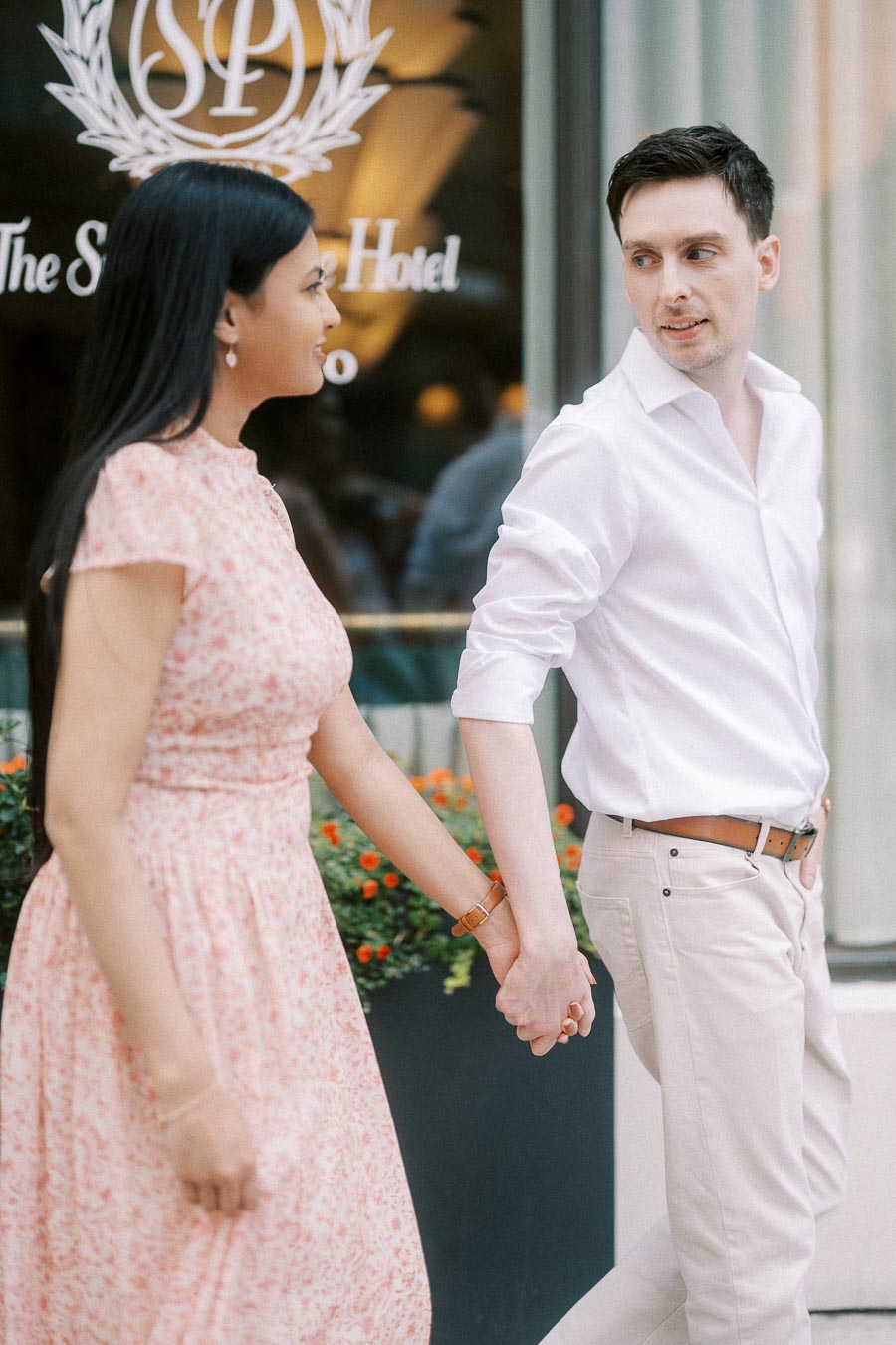 Mike and Becky holding hands outside The Sutton Place Hotel in Toronto