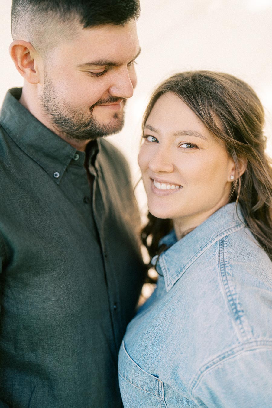Expectant couple smiling close together at The Green Acres in Flamborough, Ontario