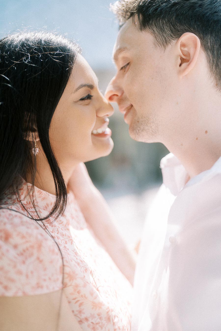 Close-up of Mike and Becky smiling face to face in soft sunlight