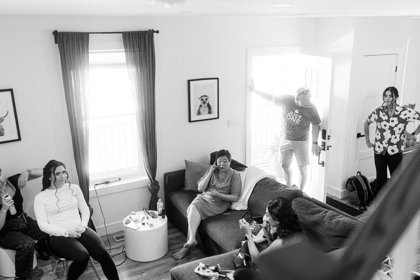 Bride and family relax in a bright getting-ready room while hair and makeup are underway.